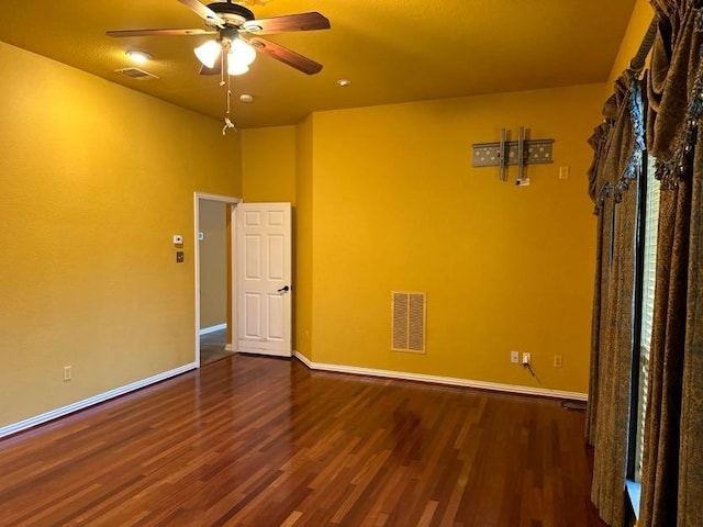 spare room featuring dark hardwood / wood-style floors and ceiling fan