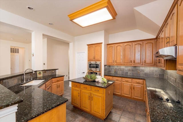 3108 Fernhurst Dr, Richardson, TX 75082 - kitchen featuring a center island, a sink, stainless steel microwave, tasteful backsplash, and under cabinet range hood