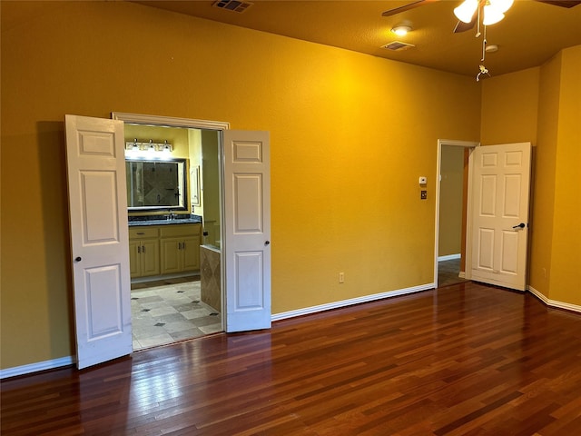 spare room featuring sink, hardwood / wood-style flooring, and ceiling fan