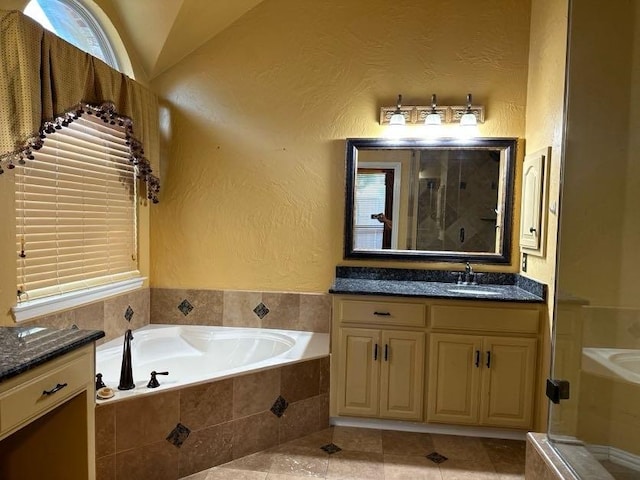 bathroom with vanity, separate shower and tub, tile patterned floors, and lofted ceiling