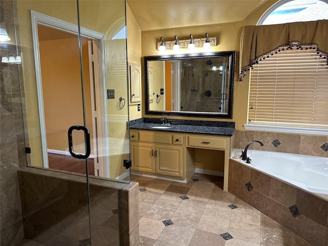 bathroom with vanity, tile patterned flooring, and shower with separate bathtub