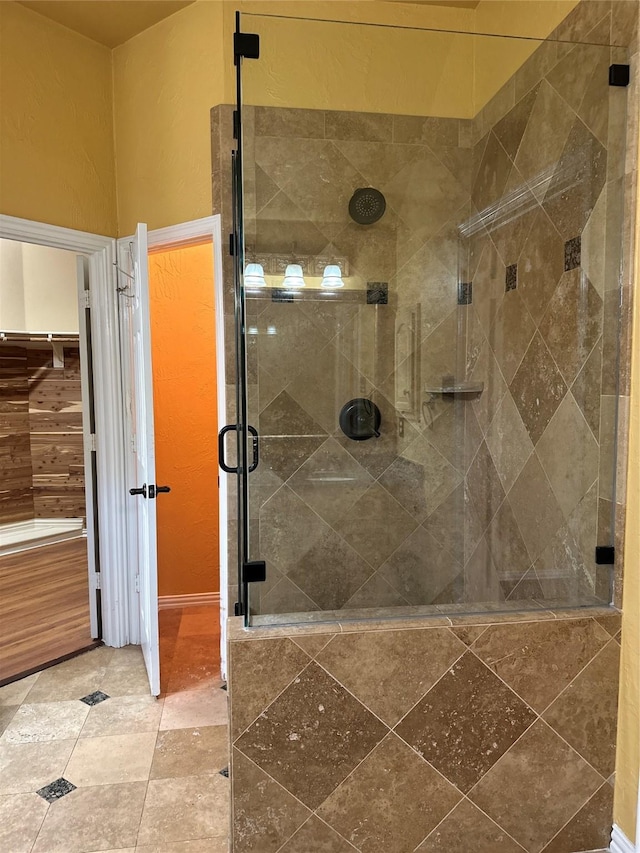 bathroom with a shower with door