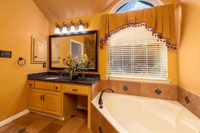 3108 Fernhurst Dr, Richardson, TX 75082 - full bath featuring tile patterned floors, lofted ceiling, a textured wall, a garden tub, and vanity