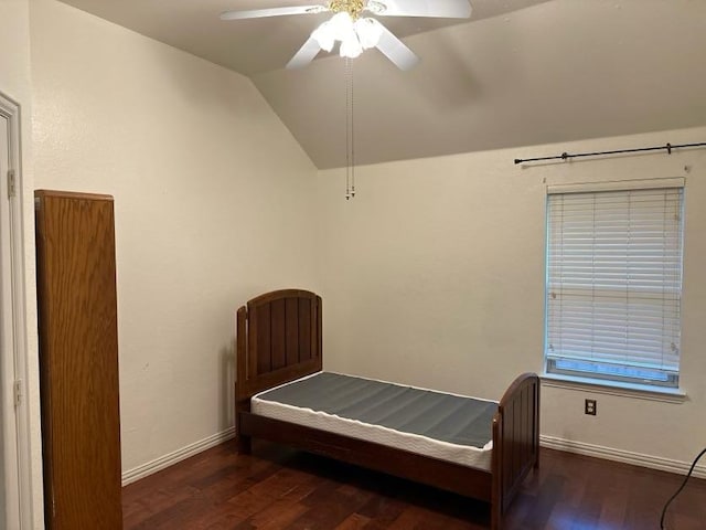 bedroom featuring vaulted ceiling, dark wood-type flooring, and ceiling fan