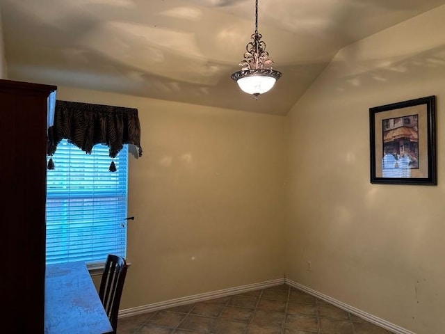 spare room with vaulted ceiling