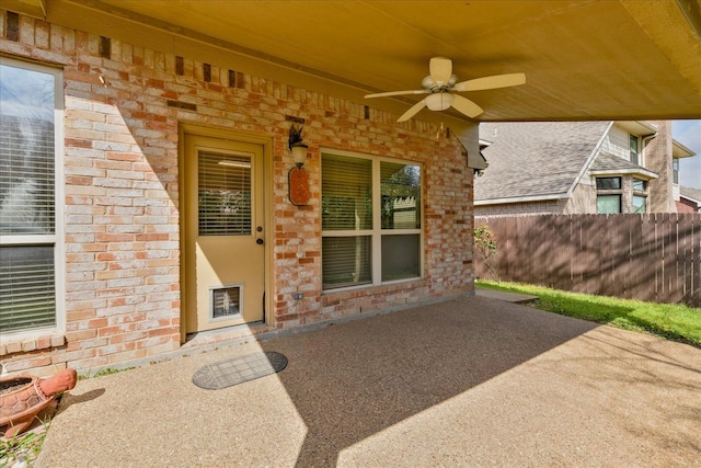 3108 Fernhurst Dr, Richardson, TX 75082 - entrance to property featuring fence, ceiling fan, a patio, stone siding, and brick siding
