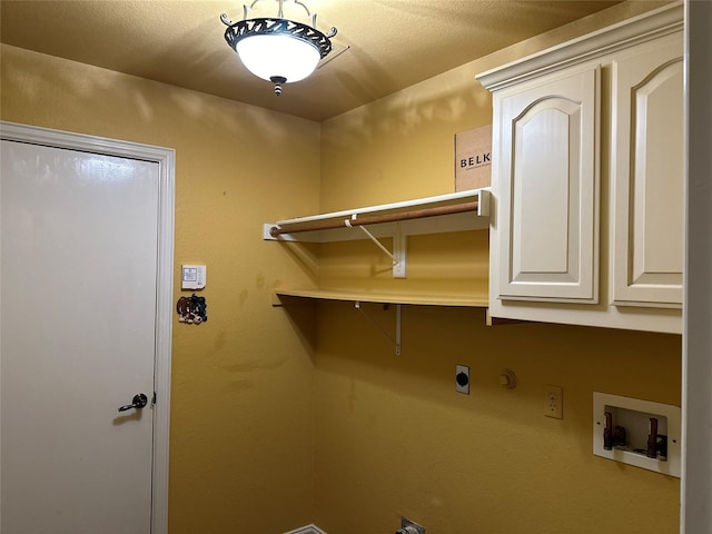 washroom featuring cabinets, washer hookup, hookup for a gas dryer, and electric dryer hookup