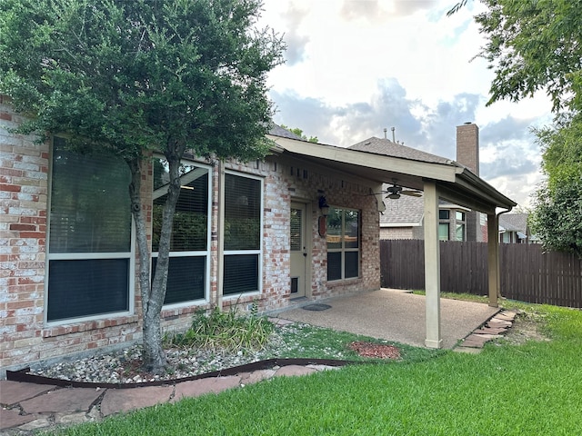 back of house with a yard, ceiling fan, and a patio area