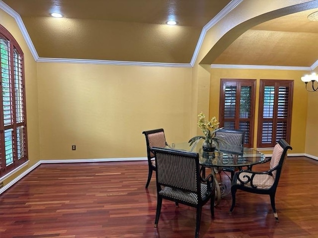 dining space featuring crown molding, lofted ceiling, and dark wood-type flooring