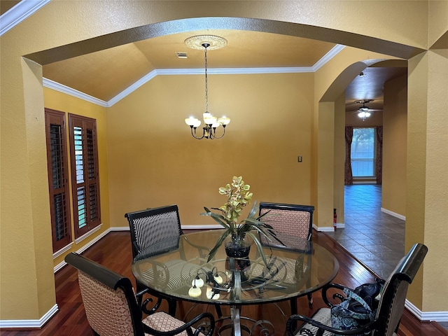 dining area with crown molding, vaulted ceiling, dark wood-type flooring, and a chandelier