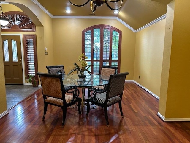 dining space with dark hardwood / wood-style flooring, crown molding, and french doors