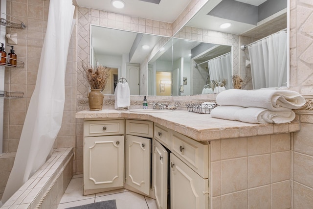 bathroom featuring shower / bath combination with curtain, vanity, tile patterned flooring, and tile walls