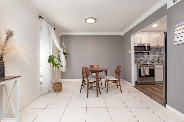 tiled dining space with ornamental molding and sink