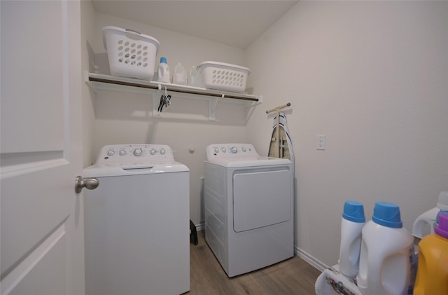 laundry room featuring separate washer and dryer and light hardwood / wood-style floors