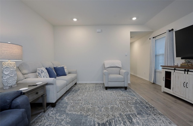 living room with lofted ceiling and hardwood / wood-style floors