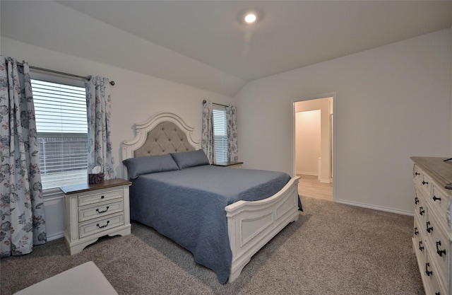 bedroom with multiple windows, carpet floors, and vaulted ceiling