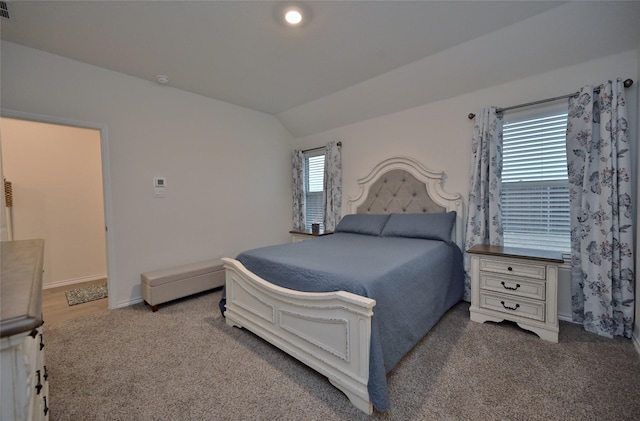 bedroom featuring lofted ceiling and carpet