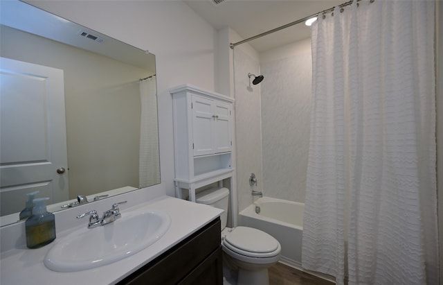 full bathroom featuring shower / bath combo, vanity, and toilet