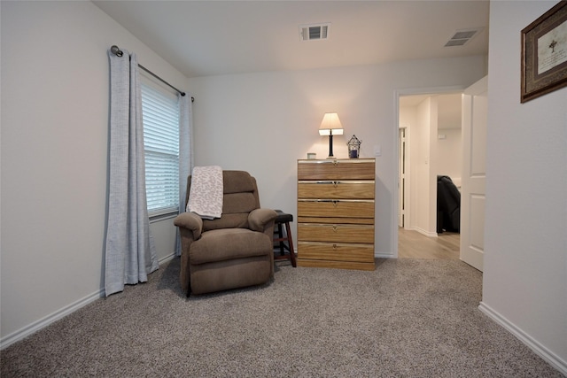 living area featuring light carpet