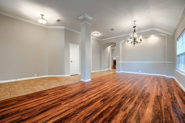 unfurnished living room featuring crown molding, wood-type flooring, vaulted ceiling, and a notable chandelier