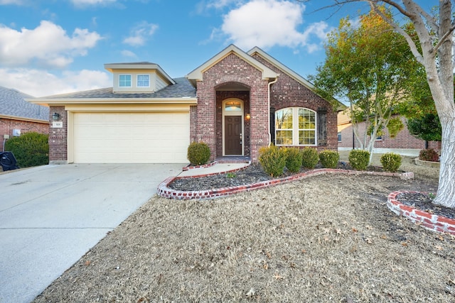 view of front of property with concrete driveway, brick siding, an attached garage, and roof with shingles