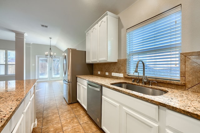 kitchen featuring light stone counters, sink, white cabinets, and appliances with stainless steel finishes