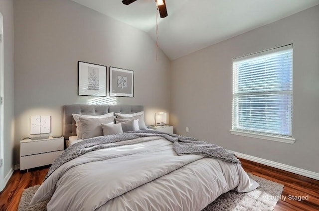 bedroom featuring vaulted ceiling, dark wood-type flooring, and ceiling fan