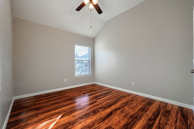 empty room with dark wood-type flooring, ceiling fan, and vaulted ceiling