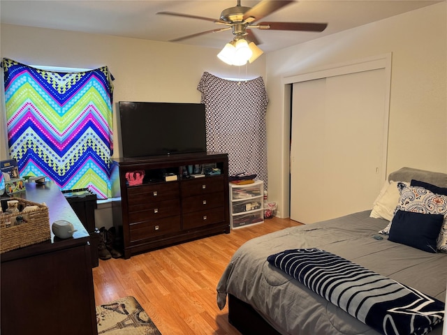 bedroom with ceiling fan, a closet, and light hardwood / wood-style flooring