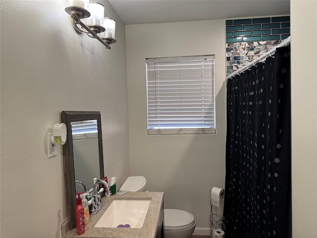 bathroom featuring vanity, curtained shower, and toilet