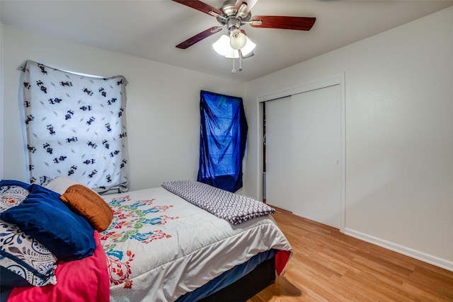 bedroom featuring wood-type flooring, a closet, and ceiling fan