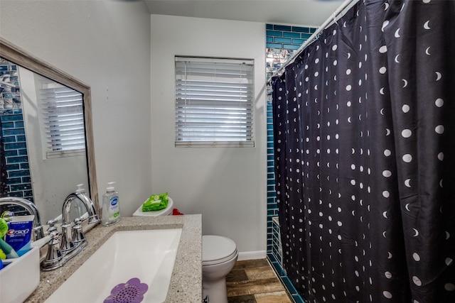 bathroom featuring sink, hardwood / wood-style floors, toilet, and a shower with shower curtain