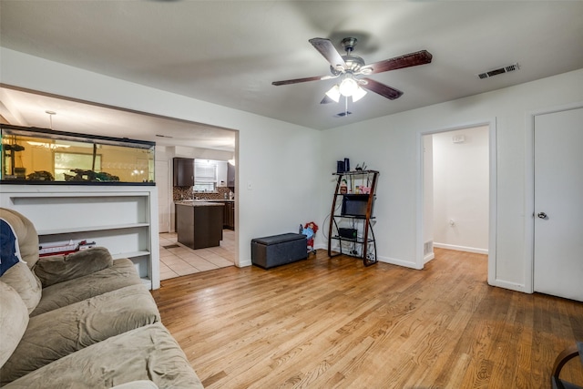 living room featuring ceiling fan and light wood-type flooring