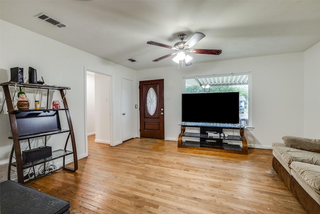 living room with ceiling fan and light wood-type flooring