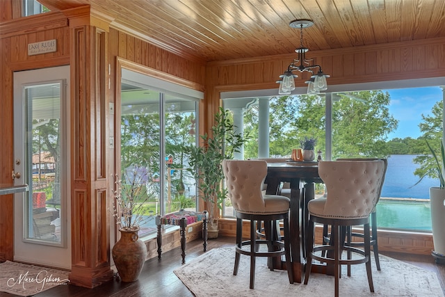 sunroom with a notable chandelier and wooden ceiling