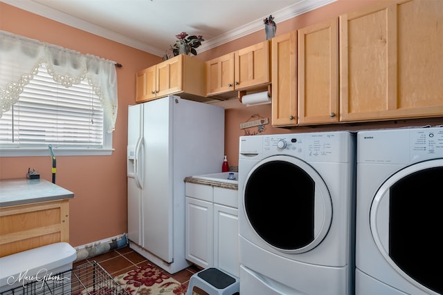 laundry area with cabinets, ornamental molding, washing machine and dryer, and dark tile patterned floors