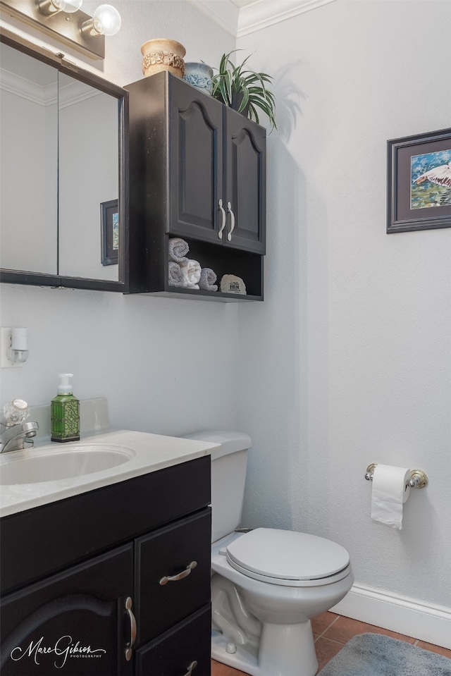 bathroom with vanity, ornamental molding, tile patterned floors, and toilet