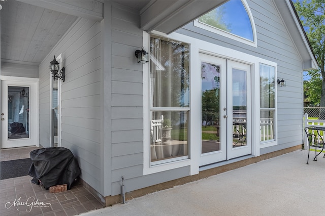 view of exterior entry with a patio