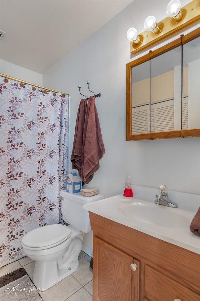 bathroom with vanity, tile patterned floors, and toilet