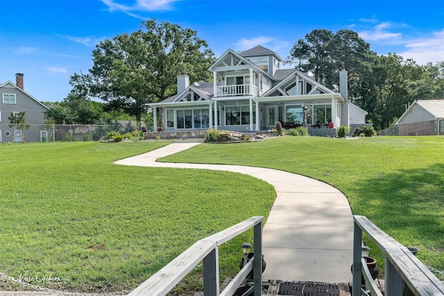 view of front facade with a balcony and a front yard