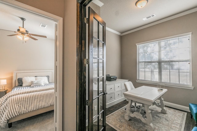 office featuring dark wood finished floors, baseboards, ornamental molding, and visible vents