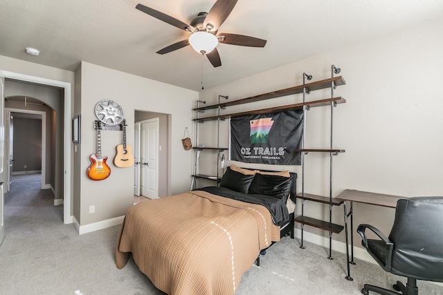 carpeted bedroom with ceiling fan and baseboards