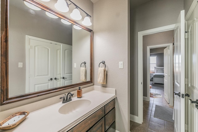 bathroom featuring baseboards, vanity, and tile patterned floors