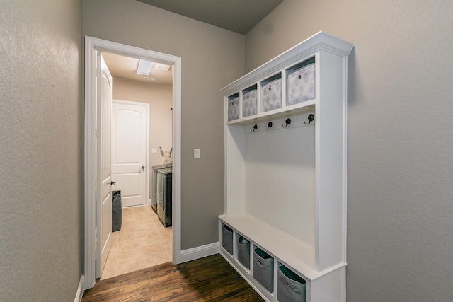 mudroom featuring baseboards and dark wood-type flooring