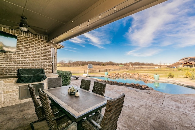 view of patio featuring a fenced in pool, a rural view, and ceiling fan