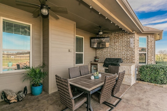 view of patio / terrace featuring outdoor dining area, a ceiling fan, and area for grilling