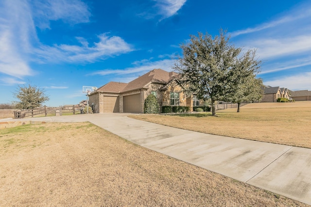 view of front of home featuring a garage and a front lawn