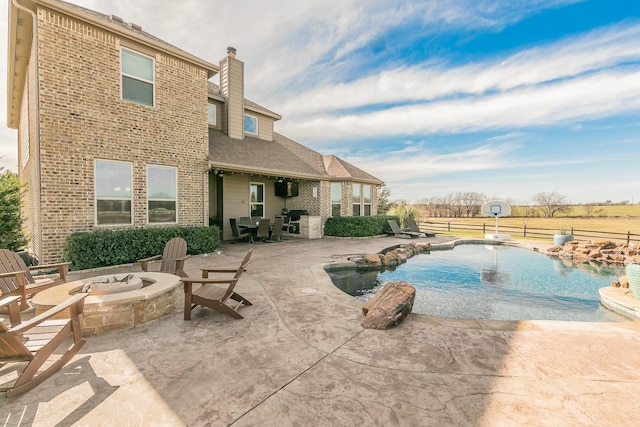 view of pool with a fire pit, a fenced in pool, a patio, and fence