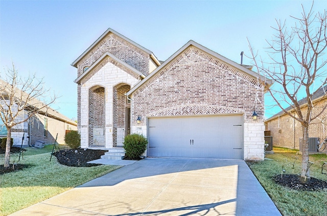 view of front of property with a garage, central AC unit, and a front lawn