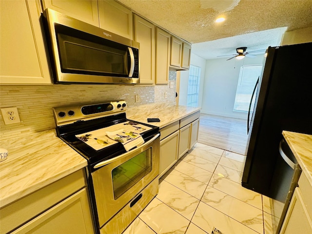 kitchen with wood counters, tasteful backsplash, a textured ceiling, ceiling fan, and stainless steel appliances